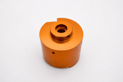 Yellow anodized aluminum CNC machined housing with threaded interfaces